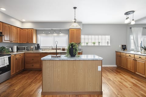 Modern kitchen with island for cooking and socializing.