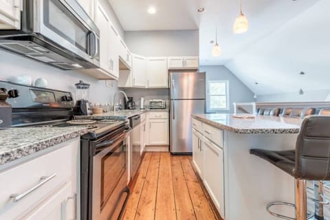 The kitchen features granite countertops, stainless appliances,