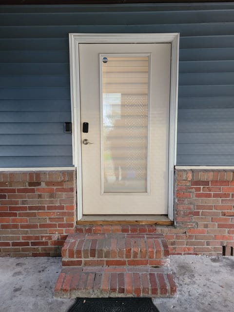 Side door entry under the carport with code enable smart lock.