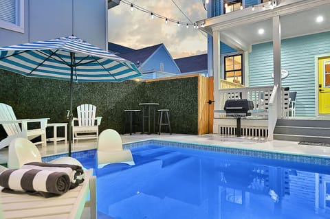 Crystal clear pool with waterfall and serene lounging. 