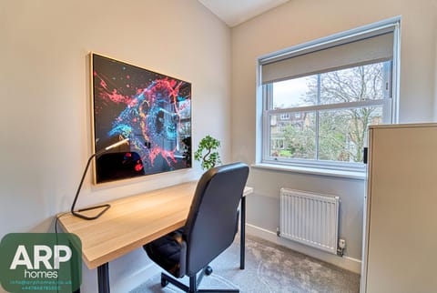 Comfy room with workspace and cozy decor for productivity.