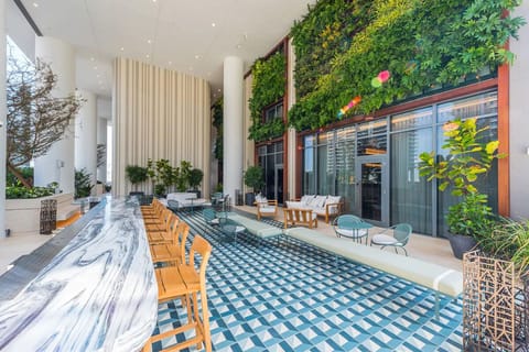 Gather in the airy lounge with greenery and spacious seating.