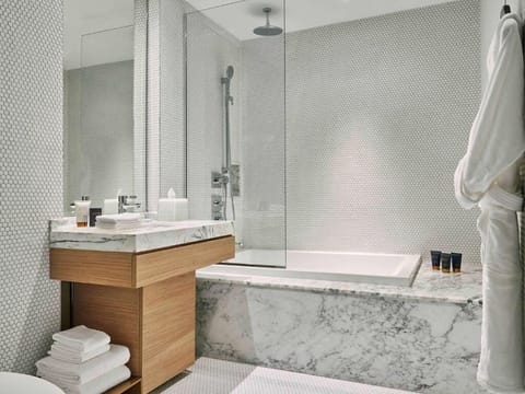 Soak peacefully in a deep tub framed by cool marble.