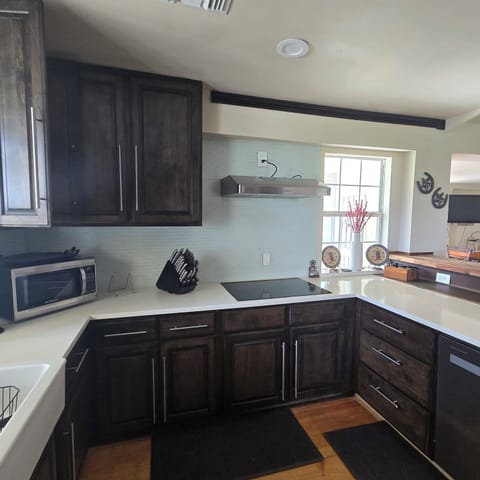 cook top, microwave, and fully stocked kitchen for preparing meals 