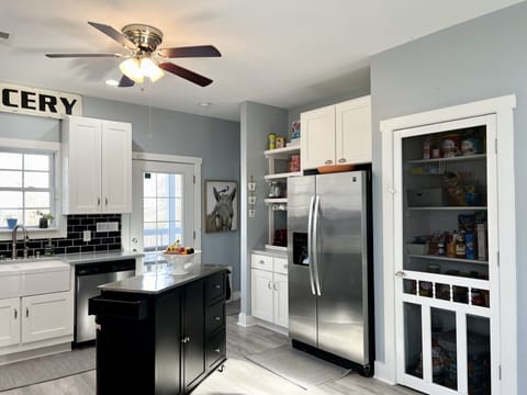 Pantry to your right and lots of tall, white cabinetry for all you need. 
