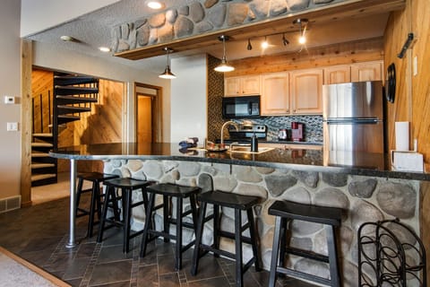 Roomy Kitchen with Six Barstools for Eating. 