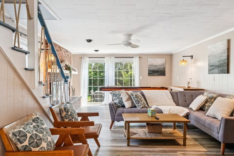 Living room with shuffleboard, Smart TV with the ability to login to streaming platforms, and access to the backyard!