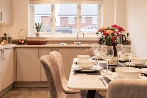 The Kitchen/Dining Space: with plenty of tableware you can cook up a storm and enjoy meals together at the dining table.