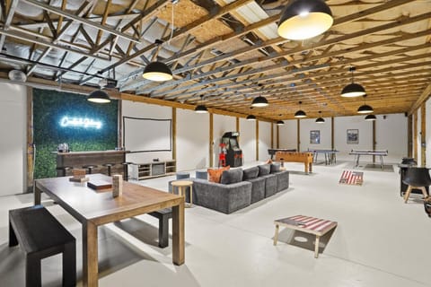 Game Garage: A dedicated entertainment retreat with arcade-style games, oversized seating, and a cinematic projector setup — because vacation should never be boring.