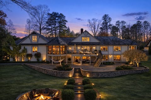 Exterior view of home from lake at sunset