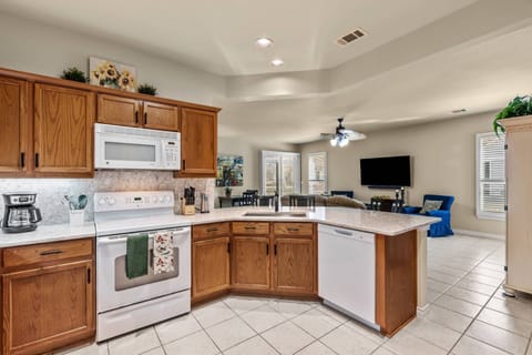 Spacious Kitchen with gleaming Quartz counters opens to the Family Room.