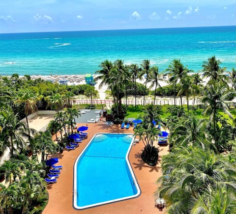 Soak up ocean breezes with a resort pool-and-beach panorama