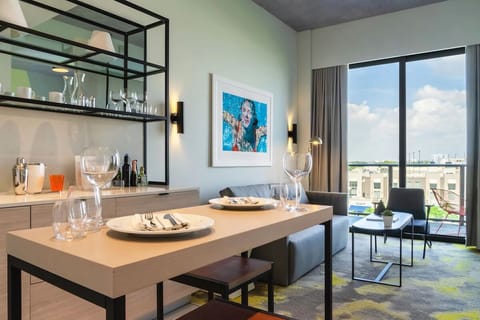 Sip wine at the table while city views glow outside.