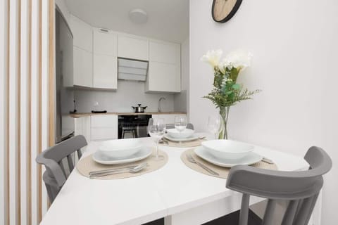 A stylish kitchen with white cabinetry, a built-in oven, and a compact but functional design for everyday convenience.


