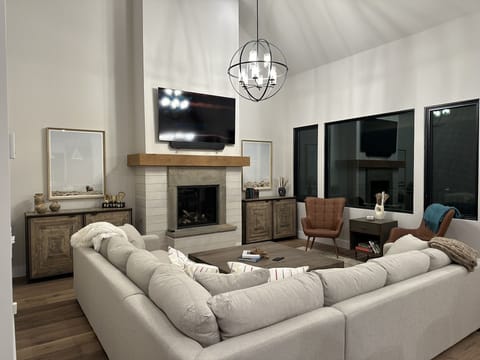 Spacious living room: comfy couch, smart TV, big coffee table to play games