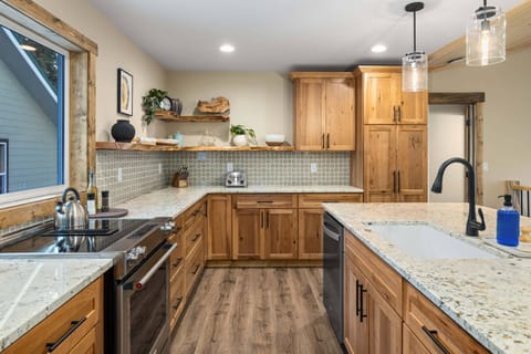Kitchen with refrigerator, microwave, dishwasher, Keurig K-Duo, convection oven and range. Also features a tall pantry cabinet for you to put your food items when you arrive.