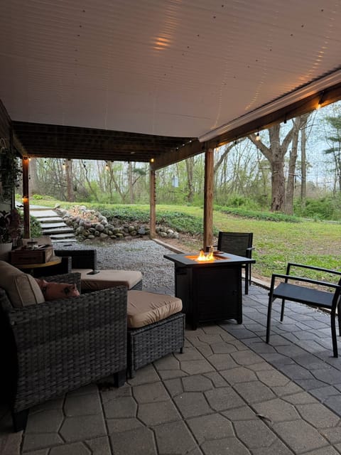 Outdoor space under deck with sesting and fireplace