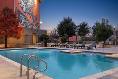 Soak in the calm evening glow beside the sparkling pool.