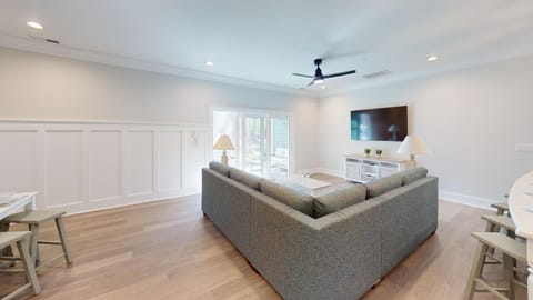A welcoming open-plan living room with ample seating — perfect for family gatherings and relaxing after a day at the beach.