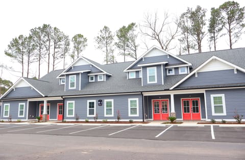 Newly built three-bedroom townhome with modern architecture, inviting front entrance, and beautifully landscaped surroundings.