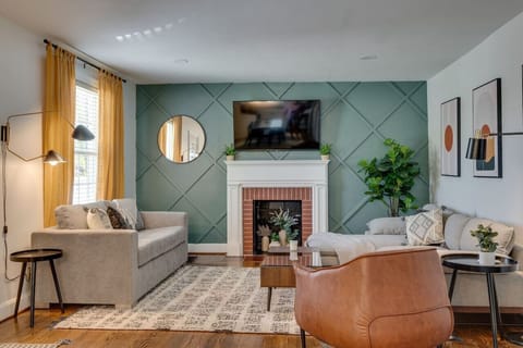 Inviting living room with a Smart TV and two couches - one of which serves as a comfortable Queen pull-out bed.