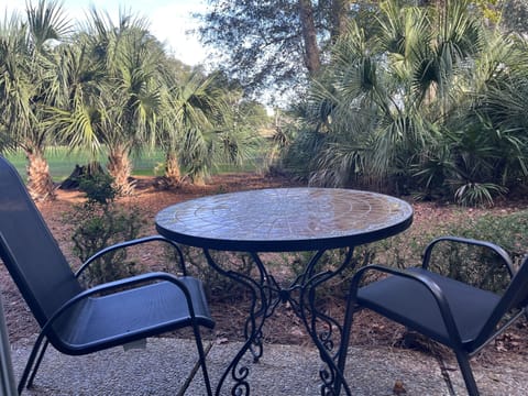 Walk out the living room sliders to the cozy patio overlooking the golf course