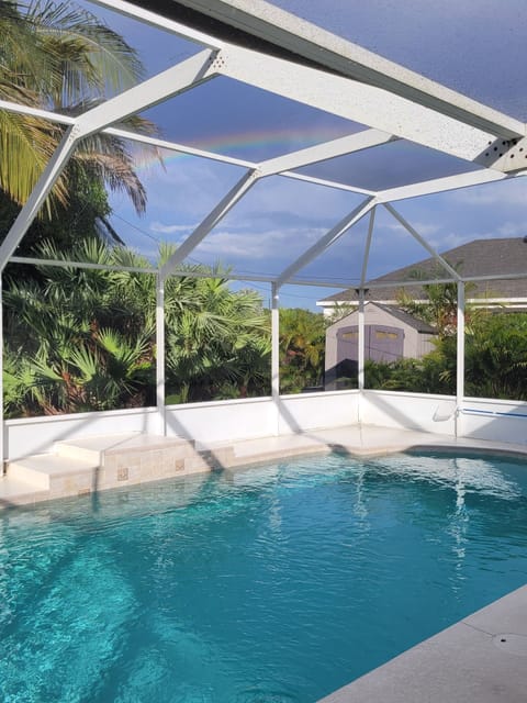 Private lush landscaping surrounds salt water pool