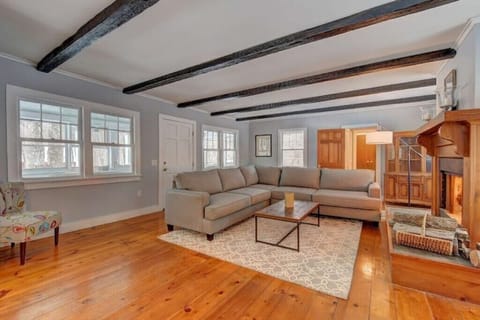 This living room has an oversized sectional with a large fireplace and smart TV.