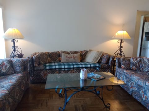 Living room with 3 couches and TV