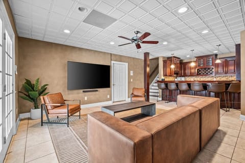 Luxurious basement bar/lounge with THREE 80 inch tv`s.