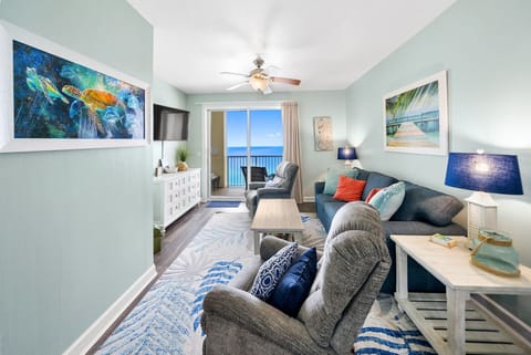 Unwind in this bright coastal living room where ocean-themed art and plush seating create your perfect seaside retreat.
