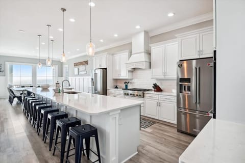 The kitchen island provides additional counter space for serving snacks or meals