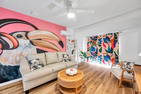 Inviting living area featuring bold artwork, comfy seating & a warm, welcoming vibe.
