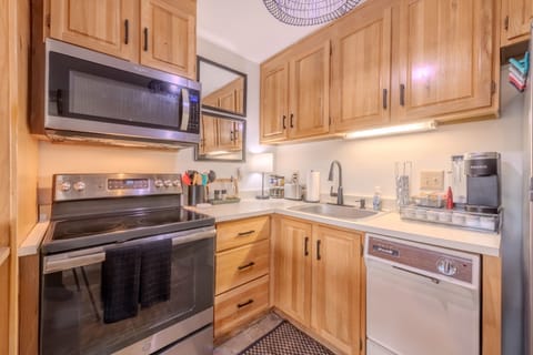 Fully stocked kitchen with appliances, plates, glasses, & utensils. 