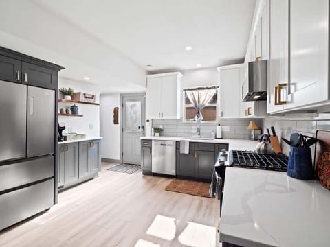 - Spacious kitchen with stainless steel appliances - White and gray cabinetry with subway tile backsplash - Modern countertops and open layout for cooking
