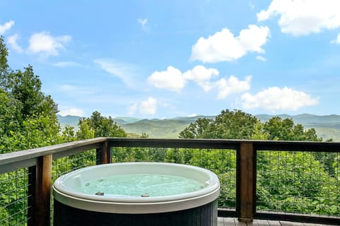 Enjoy gorgeous long-range mountain views while soaking in the hot tub on the deck.