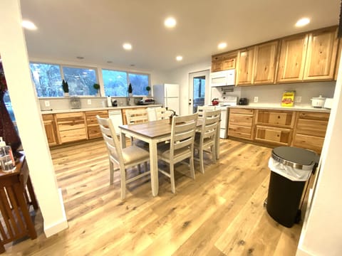 Kitchen with quarts countertops, with dining table.