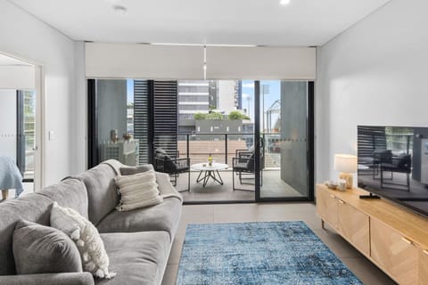 Settle into the living area, seamlessly connected to the balcony, providing a cosy spot to unwind with TV while soaking in the atmosphere.