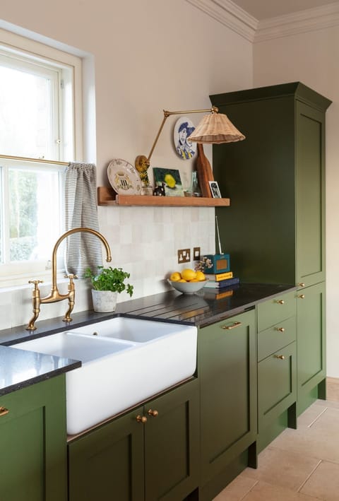 The Old Rectory - a Belfast sink and green cabinets in the bespoke kitchen