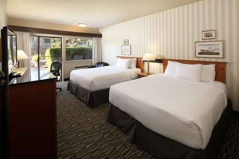 Unwind in crisp, sunlit double beds after busy days.