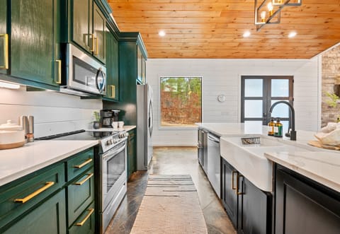 Cozy up in this chic kitchen with a cup of coffee and forest views to start your morning right.