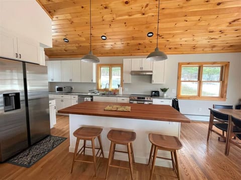 Fully Equipped kitchen with Granite Count top and Butcher block island with seating for 3