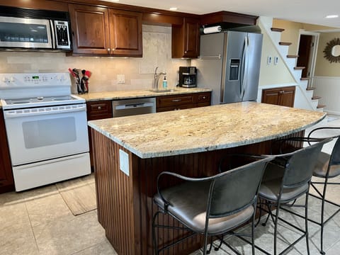 Kitchen island with seating for 3 on lower level.