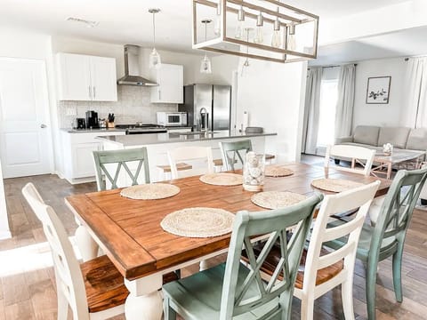 Dining Room and kitchen with ample seating at the large dining room table. 