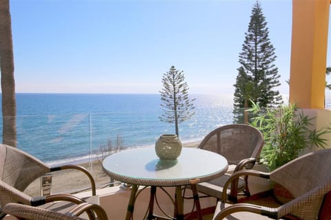 South-facing balcony with outdoor dining area for four guests and sea views