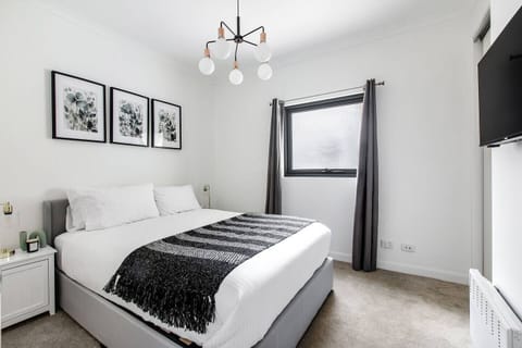 The bedroom comes with a plush queen-sized bed fronting a wall-hung TV for easy viewing.
