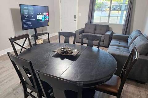 The breakfast/dining area, along with the living room and the 65'' TV for your entertainment