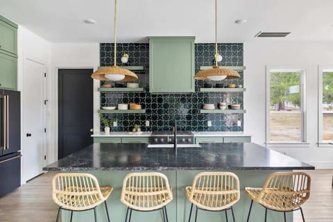 Fully stocked with basic cooking supplies including pots, pans, baking sheets, utensils, dinnerware, glassware, and basic oils/spices. 