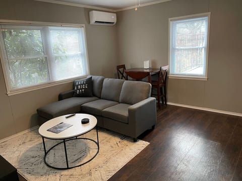 Cozy living room with natural light and a comfortable sofa.