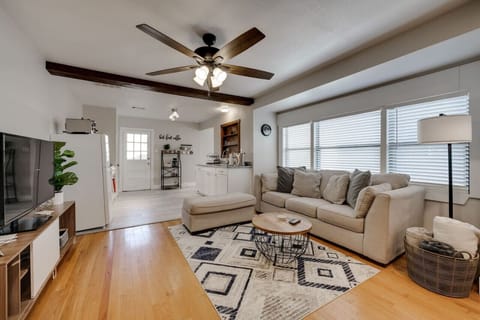 Bright and spacious living room with comfortable seating, ceiling fan, and natural light – the perfect place to unwind.